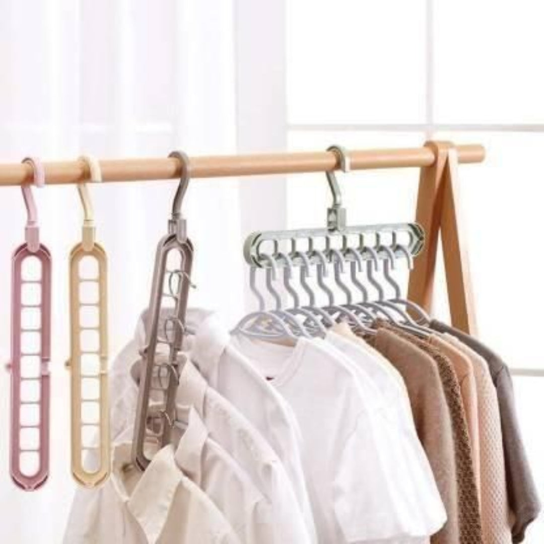 Set of multi-layered hangers on a wooden rod with clothes underneath.