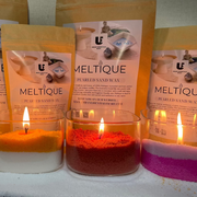 Meltlique candles with packaging on a snowy surface